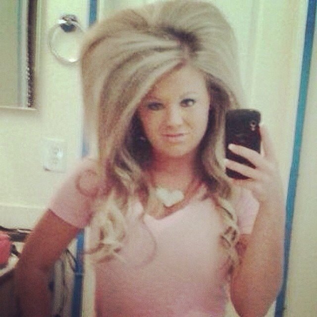 the bigger the hair the closer to god. That southern belle look..